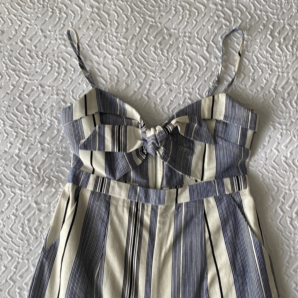Adorable jumpsuit with belly cut out tie front